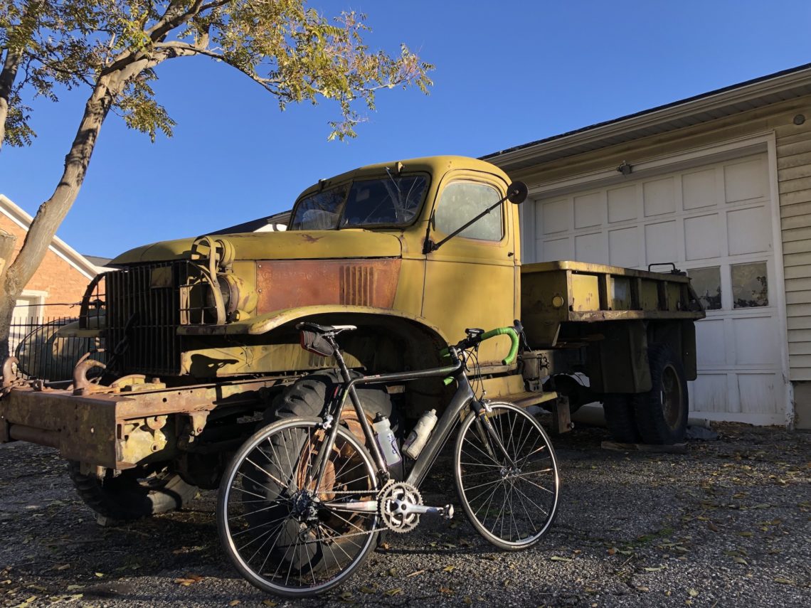 Rusted U.S. Army truck with carbon frame bicycle leaning against it