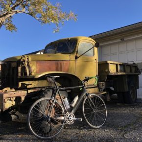 Rusted U.S. Army truck with carbon frame bicycle leaning against it